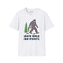 Leave Only Footprints T Shirt featuring a graphic of Sasquatch and evergreen trees on a white tee.