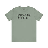 Home Is in Seattle Tee featuring campfire, Bigfoot, and tree designs showcasing Emerald City pride.