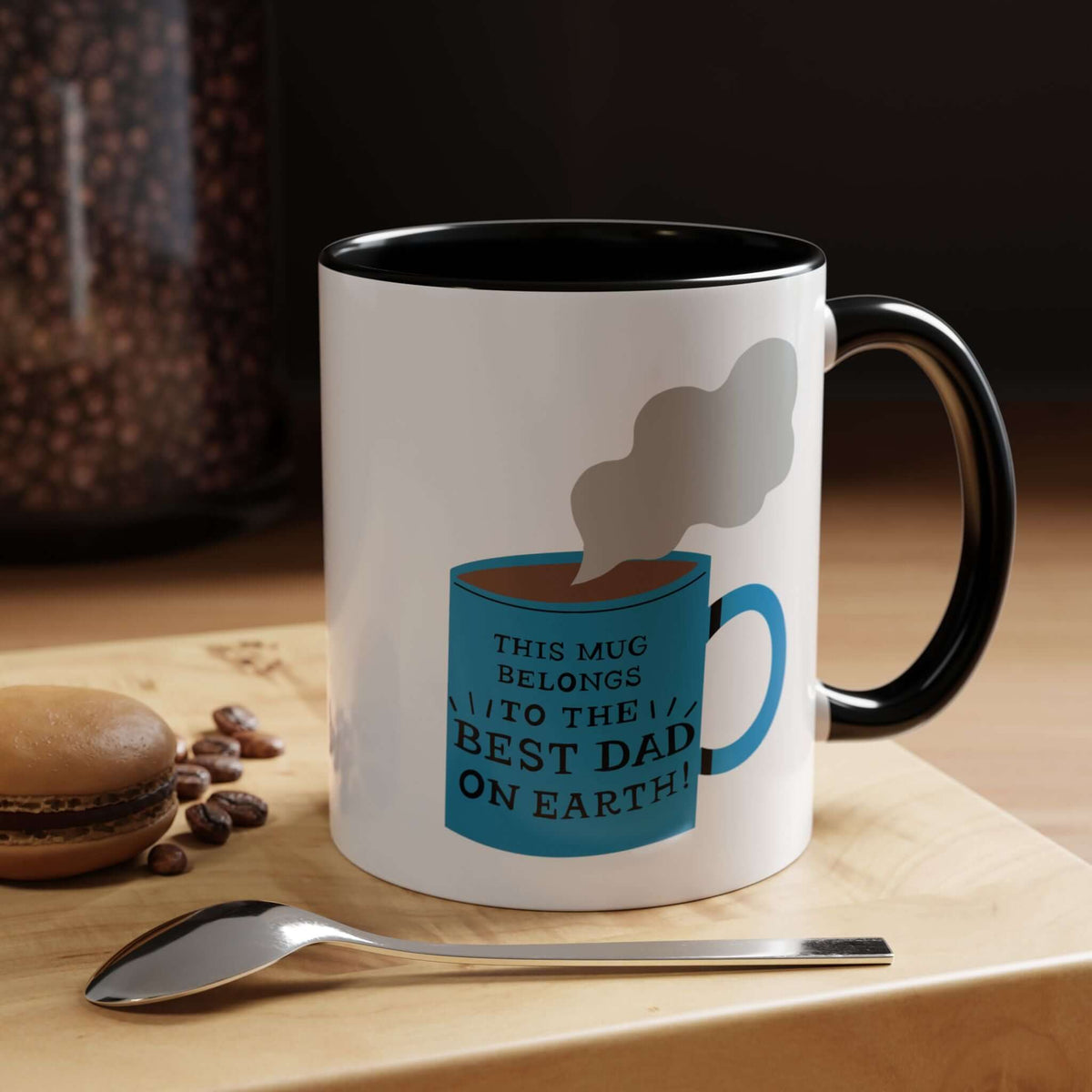 Glossy ceramic mug with playful message 'This mug belongs to the BEST DAD ON EARTH!' and steaming blue cup design.