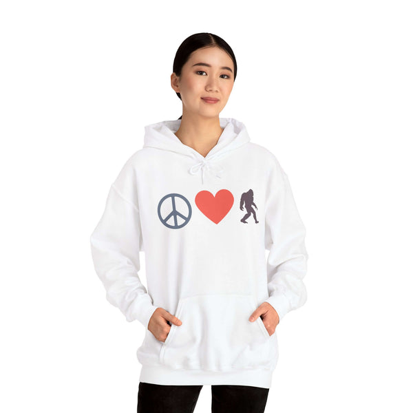 Woman wearing a Peace, Love, and Bigfoot Cozy Hoodie featuring peace symbol, heart, and Bigfoot silhouette.