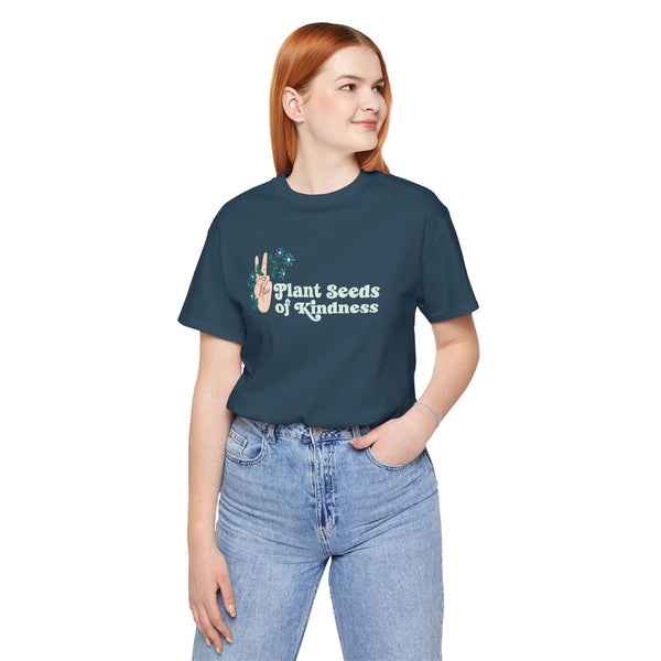 Model wearing Plant Seeds of Kindness premium tee featuring a peace sign and flowers design.