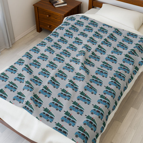 Camper van blanket featuring vintage Volkswagen buses with Christmas trees for a cozy holiday road trip.