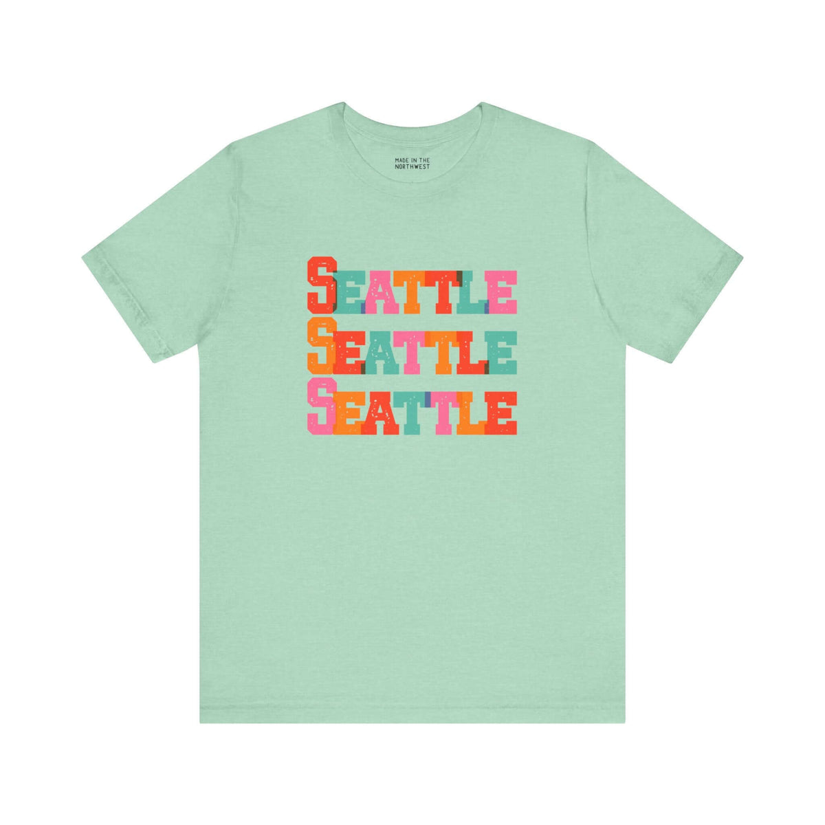 Bold and Bright Seattle Trio Soft Tee with colorful block-letter design on a mint green background.