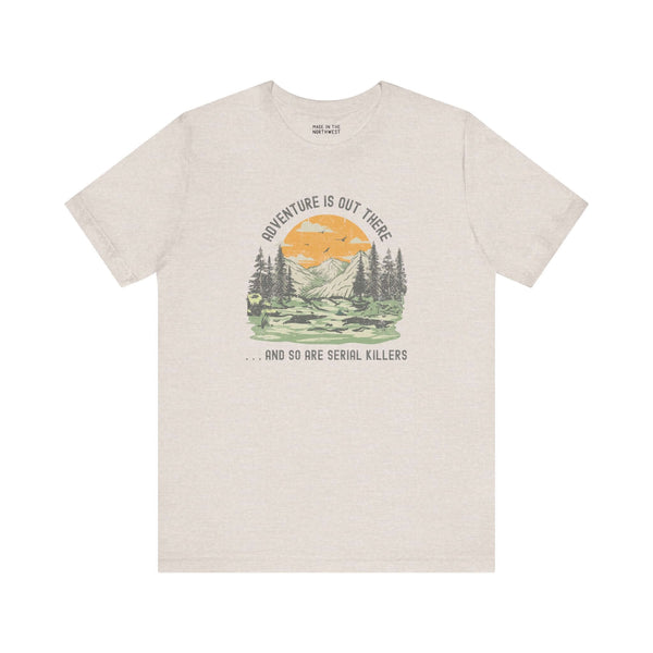 Premium soft tee with outdoor graphic and text 'Adventure Is Out There... And So Are Serial Killers'.