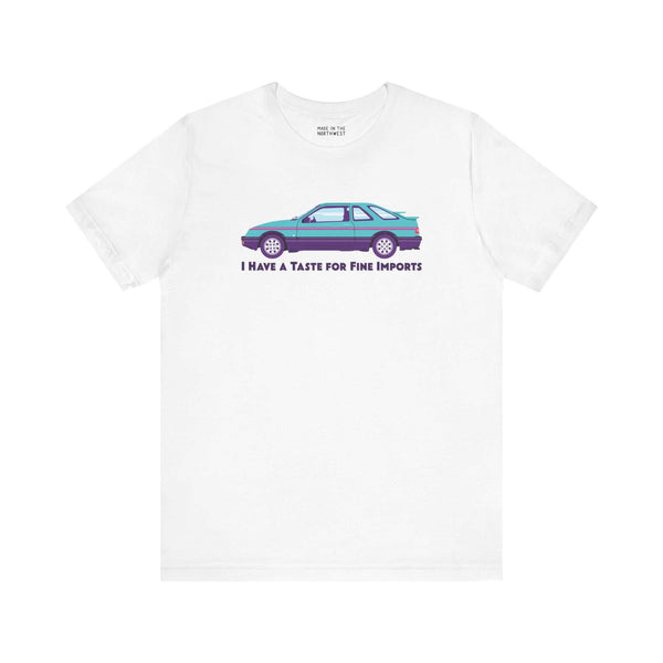 White automotive tee featuring 80s Merkur XR4TI with the slogan 'I Have a Taste for Fine Imports'.