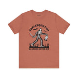 Skelesquatch Halloween soft tee featuring a skeleton sasquatch with a knife and mask, perfect for horror and cryptid fans.