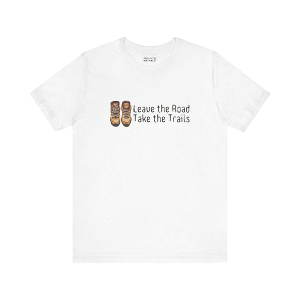 White premium soft tee featuring 'Leave the Road, Take the Trails' design with hiking boots. Perfect for outdoor adventures.