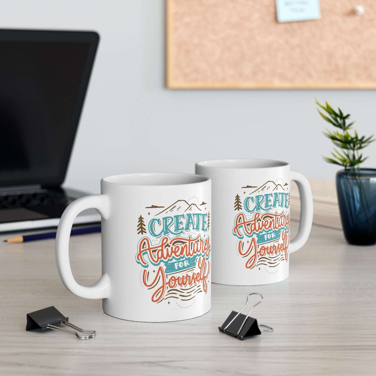 Create Adventures for Yourself Mug displayed on a desk with stationery and a corkboard in the background.