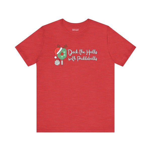 Deck the Halls with Pickleballs T Shirt in festive red with playful design elements.