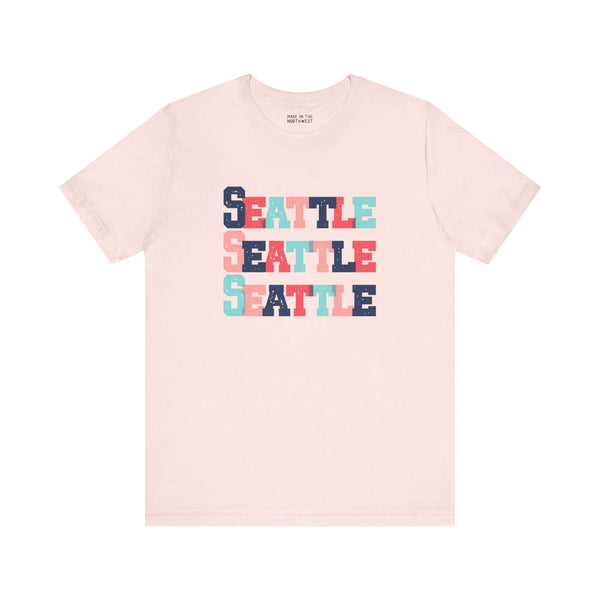 "Bold and Bright Seattle Trio Soft Tee with colorful block-letter design celebrating Emerald City style"