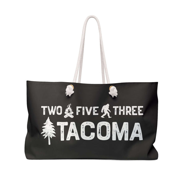 Two Five Three Roots Tacoma Weekender Bag featuring axe, Bigfoot, and tree design for PNW trips.