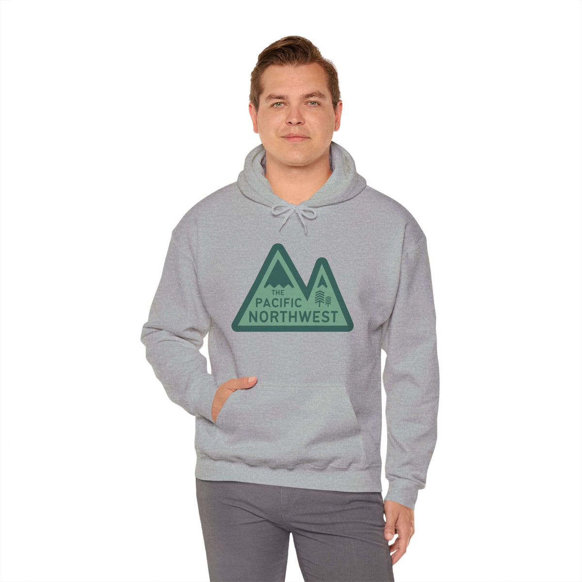 Man wearing Pacific Northwest Heights Mountain Hoodie with green mountain design on gray fabric.