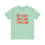 Bold and vibrant Spokane Trio Soft Tee with colorful block-letter design on a mint green shirt, perfect for Lilac City fans.