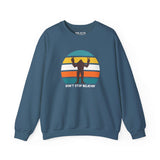 Don't Stop Believin' Bigfoot sweatshirt with playful sasquatch graphic on blue background.