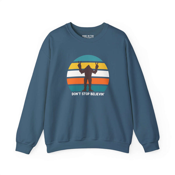 Don't Stop Believin' Bigfoot sweatshirt with playful sasquatch graphic on blue background.