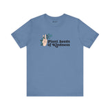 Blue tee featuring 'Plant Seeds of Kindness' with peace sign and floral design, promoting positivity and love.