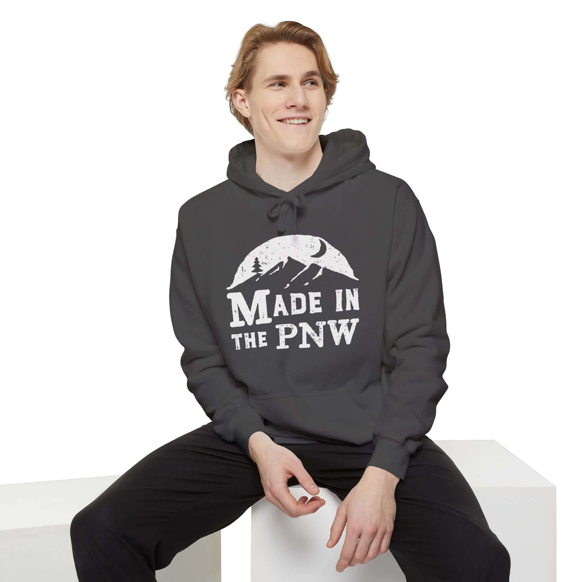 Model wearing a Made in the PNW hoodie, showcasing its relaxed fit and outdoorsy design.
