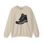 Beige sweatshirt featuring a rugged hiking boot graphic with the text "Trails Before Emails" for outdoor enthusiasts.