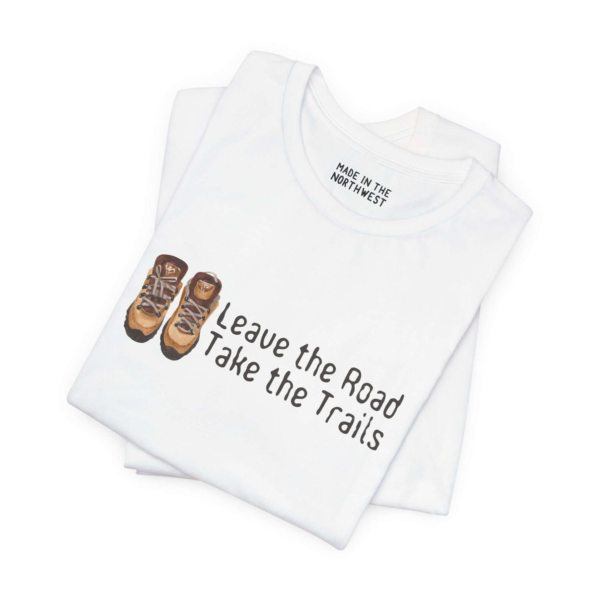 Premium soft tee with 'Leave the Road, Take the Trails' design and hiking boots, perfect for outdoor enthusiasts.