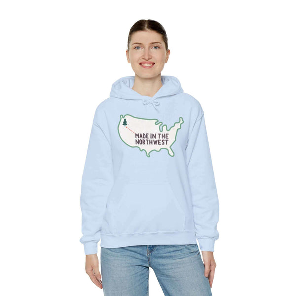 Evergreen is Where It's At Hoodie Show your love for the Pacific Northwest with our exclusive "Evergreen is Where it's At" hooded sweatshirt. This design features the woodgrain United States with a tree marking the PNW location, highlighted by an arrow an