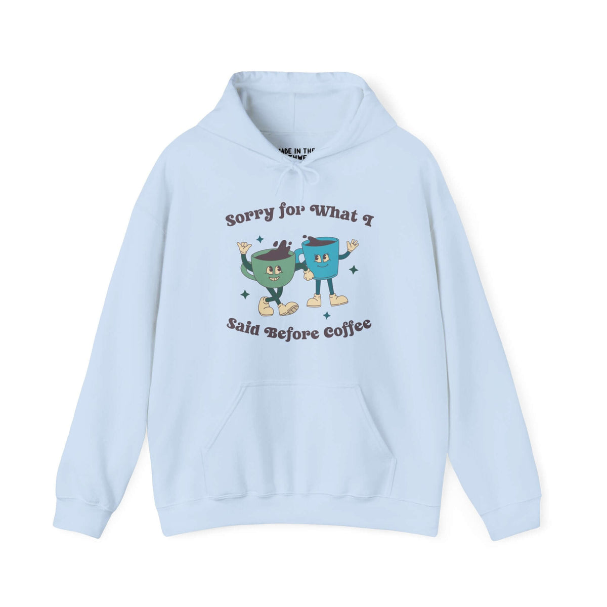 Light blue hoodie with "Sorry for What I Said Before Coffee" printed alongside cartoon coffee cups, ideal for coffee lovers.