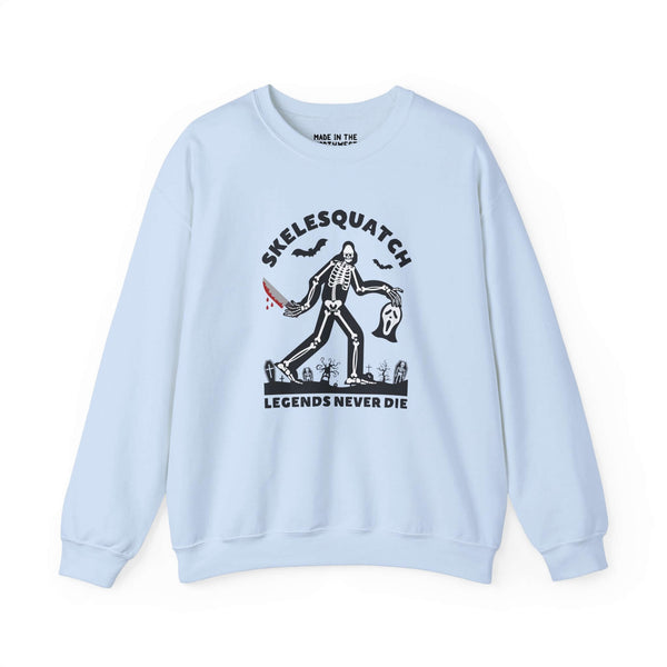 Skelesquatch Legends Never Die Halloween sweatshirt featuring a skeleton sasquatch in a graveyard.