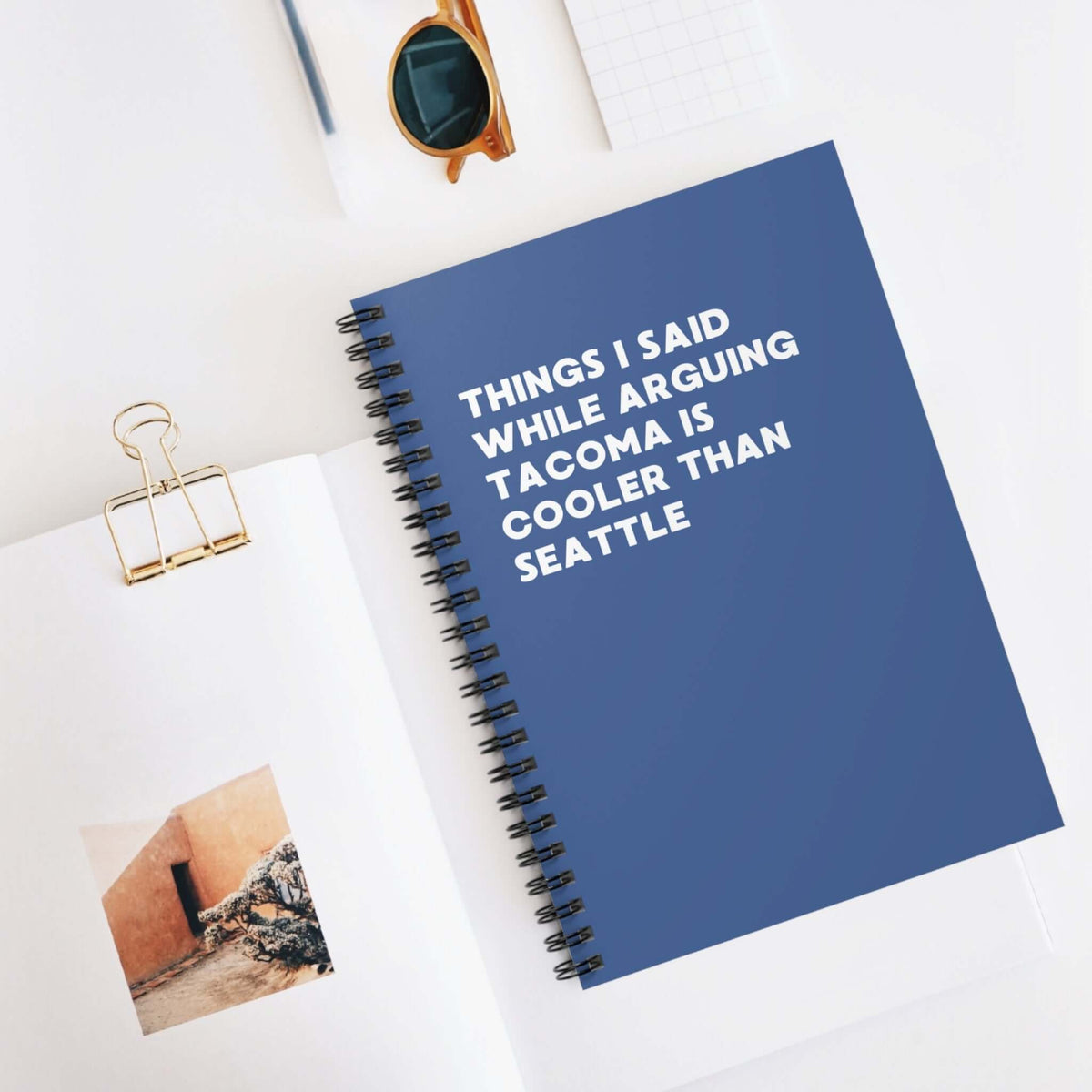 Spiral notebook featuring the title 'Things I Said While Arguing Tacoma is Cooler Than Seattle', ideal for jotting down opinions.