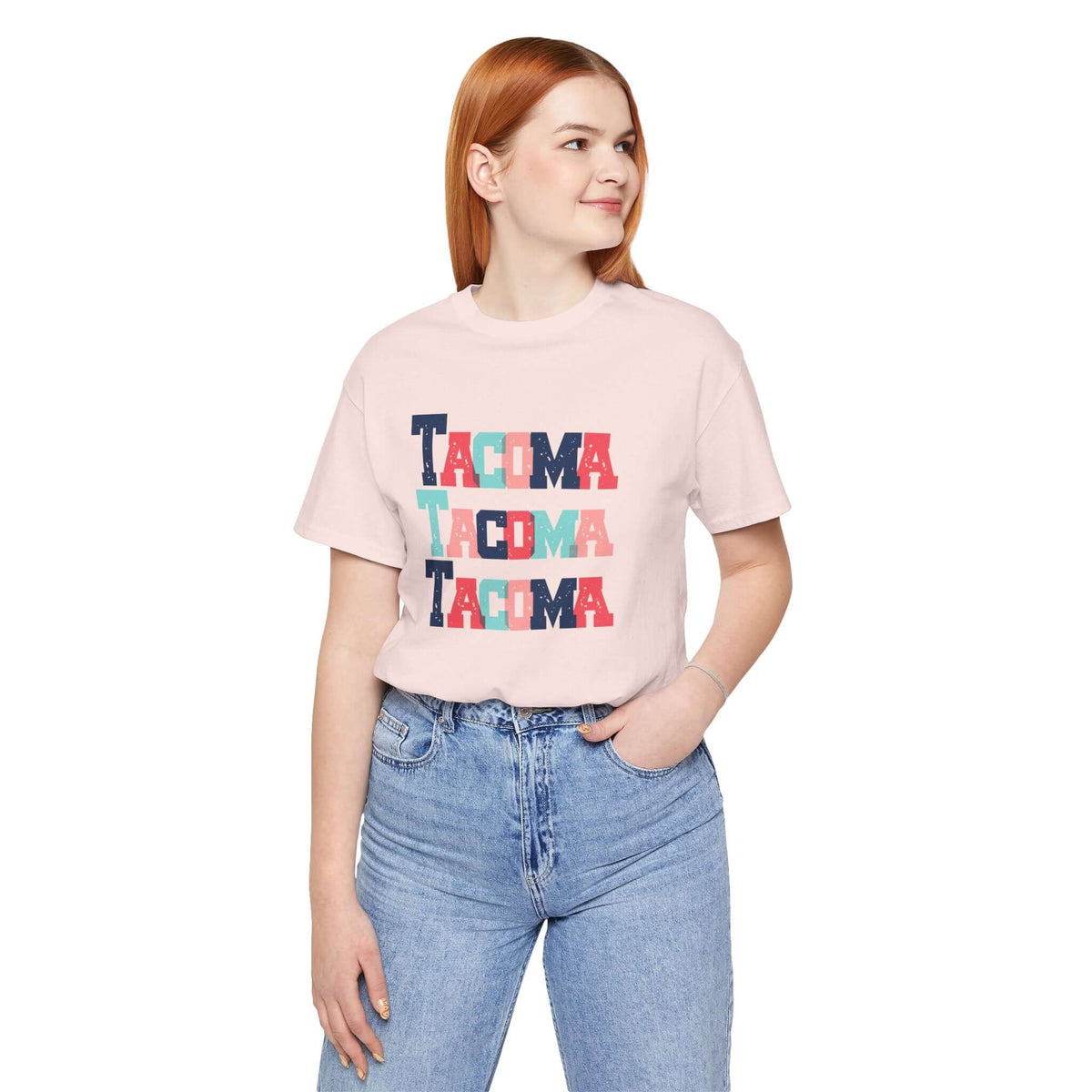 Woman wearing a Bold and Bright Tacoma Trio Soft Tee with colorful block-letter design, displaying love for Tacoma.