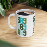 Five-Oh-Nine Pop Spokane ceramic mug with colorful 509 design on wooden surface, perfect for morning coffee.