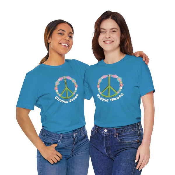 Two women wearing Choose Peace and Flowers Premium Soft Tees, featuring vibrant floral peace sign designs.