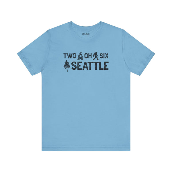 Light blue Two Oh Six Roots Tee featuring Seattle area code and tree design.