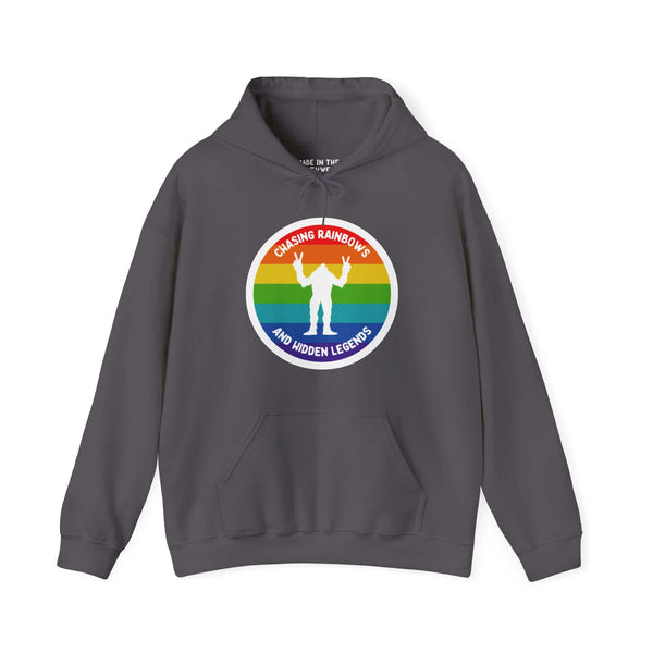 Gray hoodie featuring a vibrant rainbow circle with a white Sasquatch graphic and "Chasing Rainbows and Hidden Legends" text.