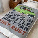 People in Seattle Don't Tan They Rust Lightweight Cozy Blanket featuring a rusty car design on a cozy bed.