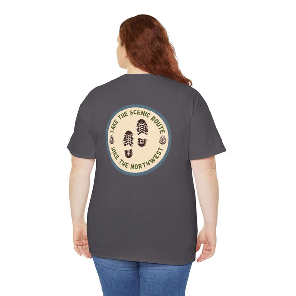 Woman wearing 'Take the Scenic Route - Hike the Northwest' athletic tee, showing off nature-themed print on the back.