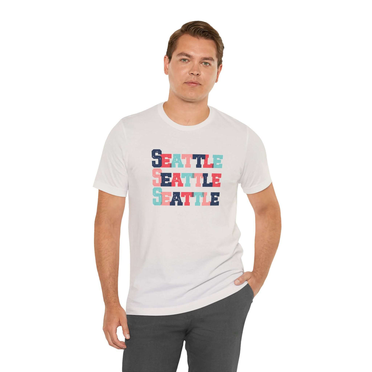 Man wearing a white tee shirt with a colorful Seattle graphic design in block letters.