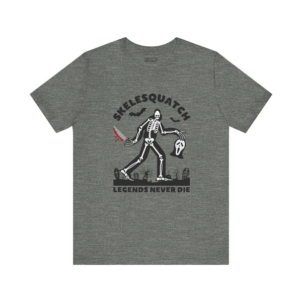 Skelesquatch Halloween tee with skeleton sasquatch, bloody knife, scream mask graphic on gray shirt, perfect for horror and cryptid fans.