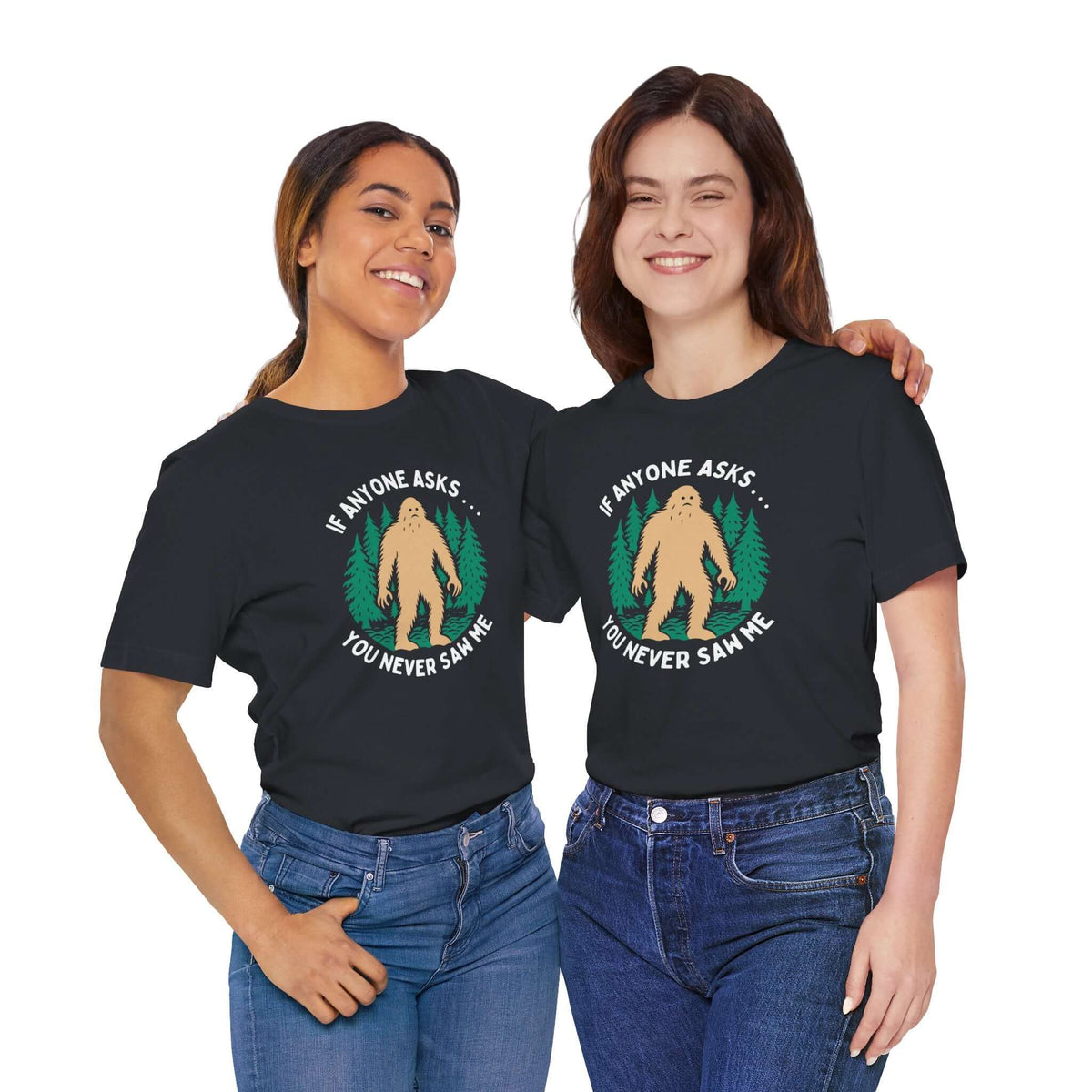 You Never Saw Me Tee, featuring Bigfoot silhouette and humorous text, worn by two women in casual attire.