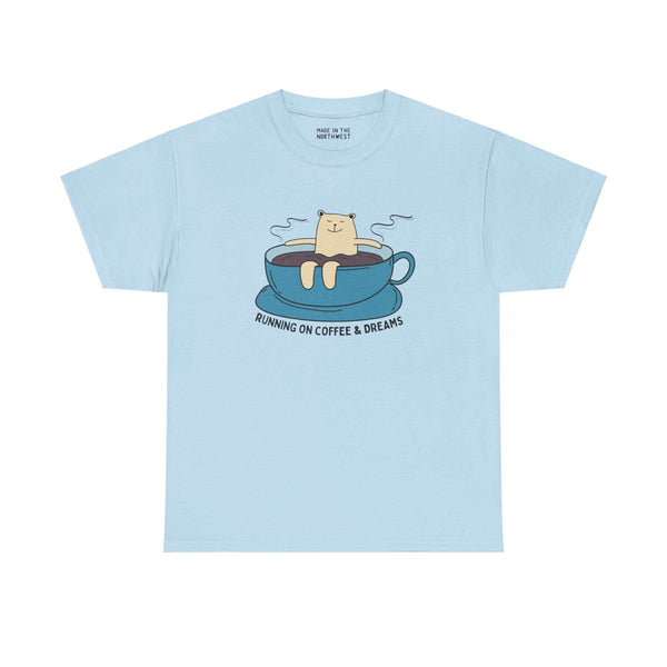 Light blue athletic tee with a bear lounging in a coffee cup, featuring the text "Running on Coffee and Dreams." Perfect for coffee lovers.