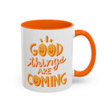 Good Things Are Coming Mug with cheerful design and vibrant orange interior, featuring playful lettering.