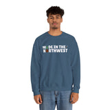 Model wearing a cozy blue sweatshirt that says 'Made in the Northwest', perfect for nature lovers and PNW fans.