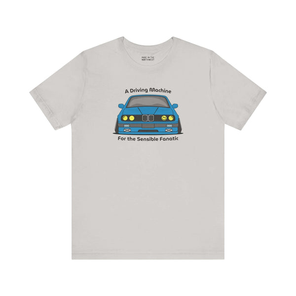 T-shirt featuring the BMW E30 325is design, titled 'A Driving Machine for the Sensible Fanatic', in soft fabric.