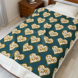 Oregon State of Mind Heart Lightweight Cozy Blanket spread on a bed showcasing heart designs.