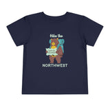 Hike the Northwest toddler tee showing a bear with a backpack and map on a navy background.