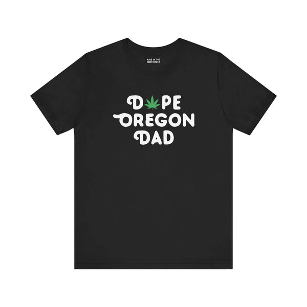 Black tee with "Dope Oregon Dad" text, featuring a marijuana leaf in place of the "O" in "Dope," showcasing Oregon pride.