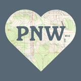 PNW Explorer's Heart tee design featuring a topo map heart shape with bold 'PNW' lettering.