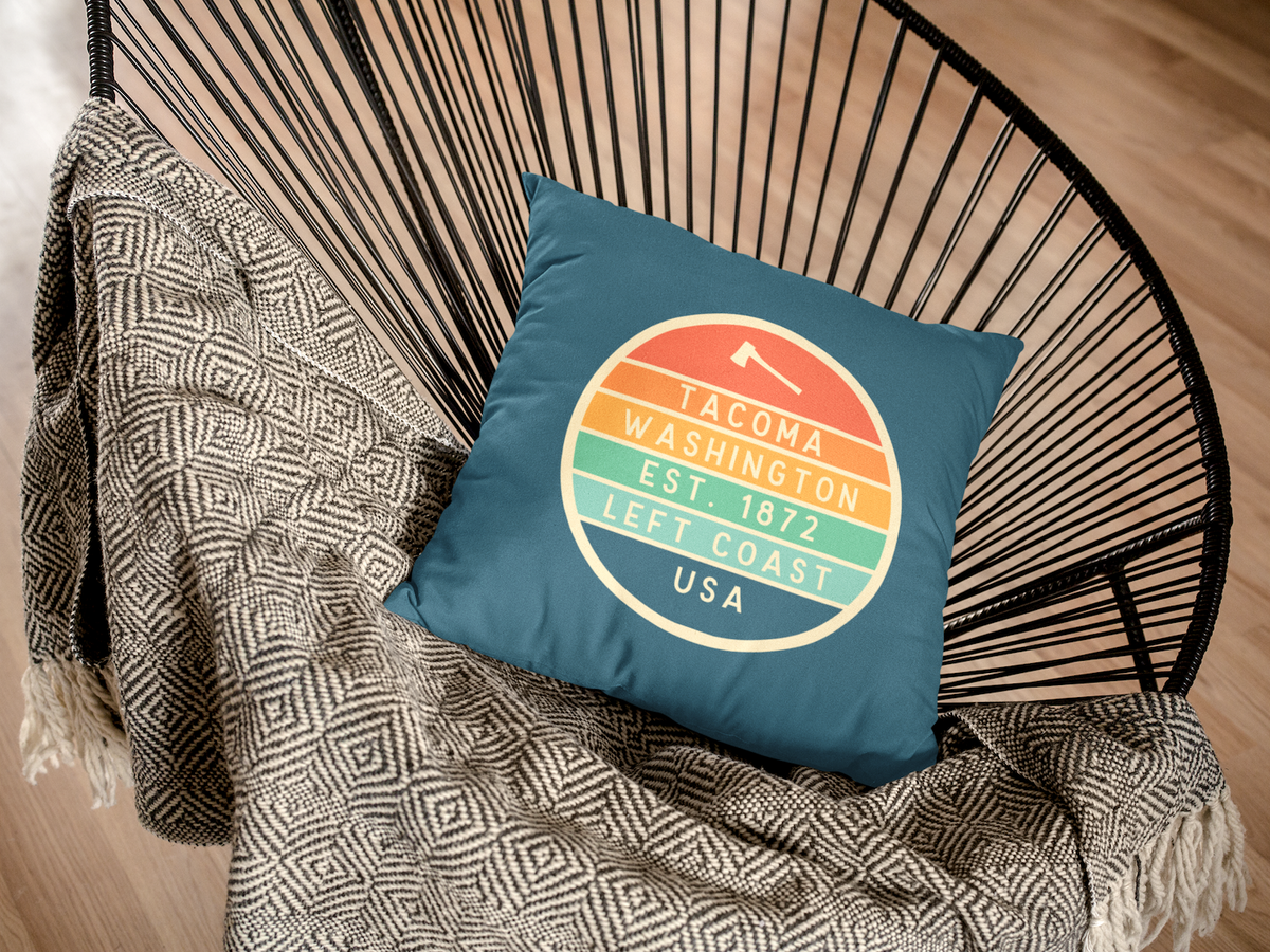 Left Coast Retro Tacoma Washington Square Accent Pillow on a stylish chair, showcasing Tacoma charm and vintage design.