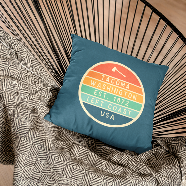 Left Coast Retro Tacoma Washington Square Accent Pillow on a stylish chair, showcasing Tacoma charm and vintage design.