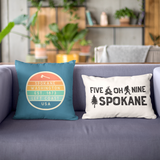 Left Coast Retro Spokane Washington Square Accent Pillow showcasing vibrant designs on stylish couch.