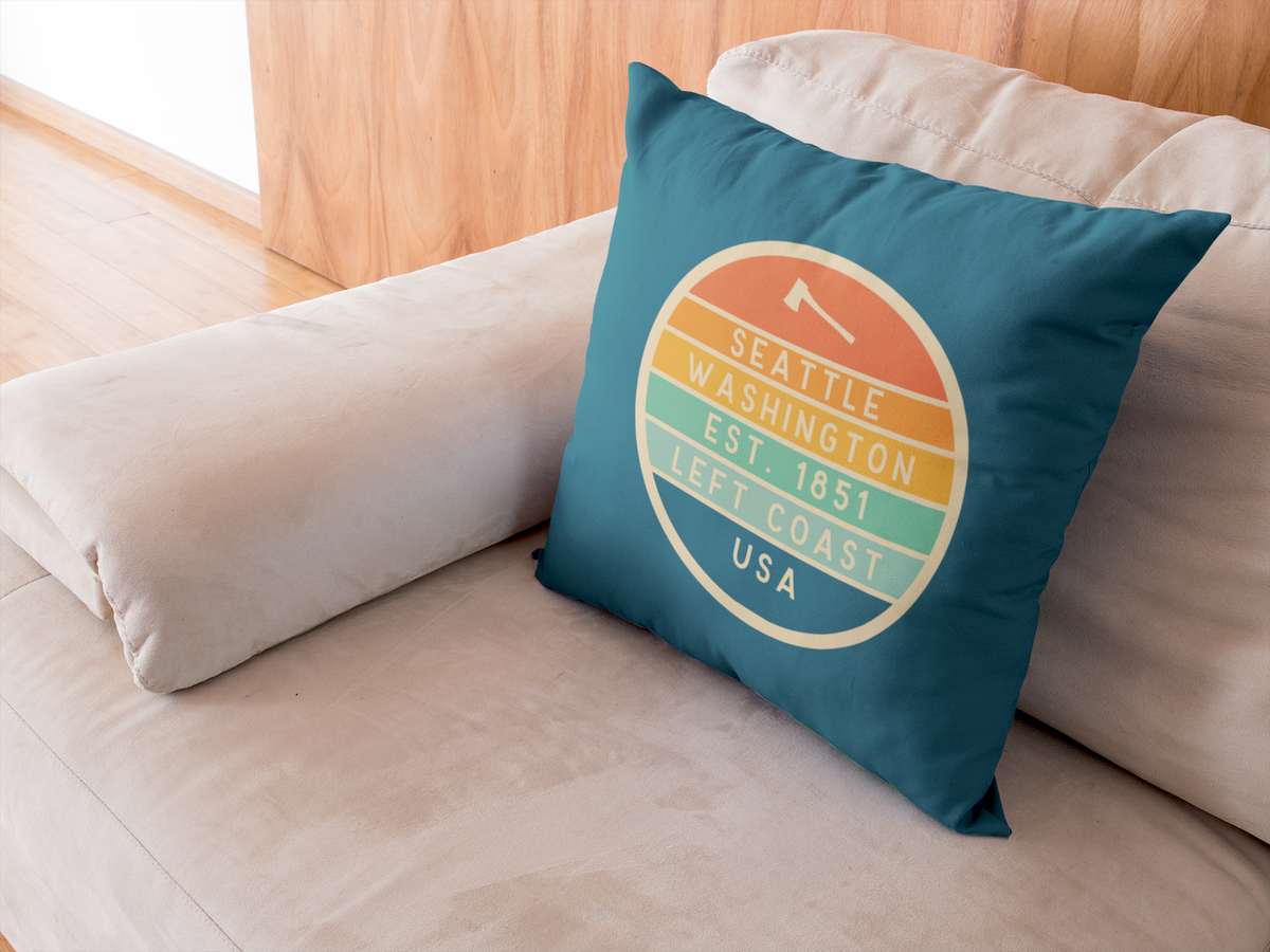 Left Coast Retro Seattle Washington Square Accent Pillow on a cozy couch, showcasing Seattle pride with retro design.