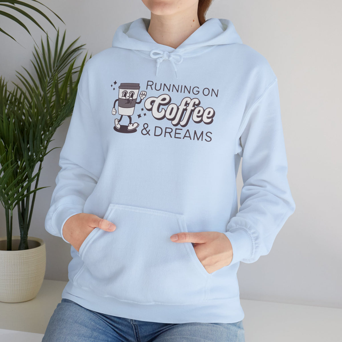 Light blue cozy hoodie with 'Running on Coffee & Dreams' design featuring a vintage coffee cup illustration.